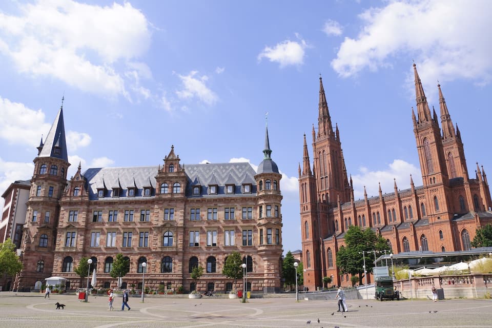 A historic building with multiple spires and a large church with tall towers.