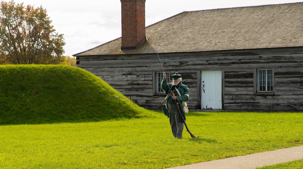 Fort George National Historic Site showing a small town or village and heritage elements as well as an individual male