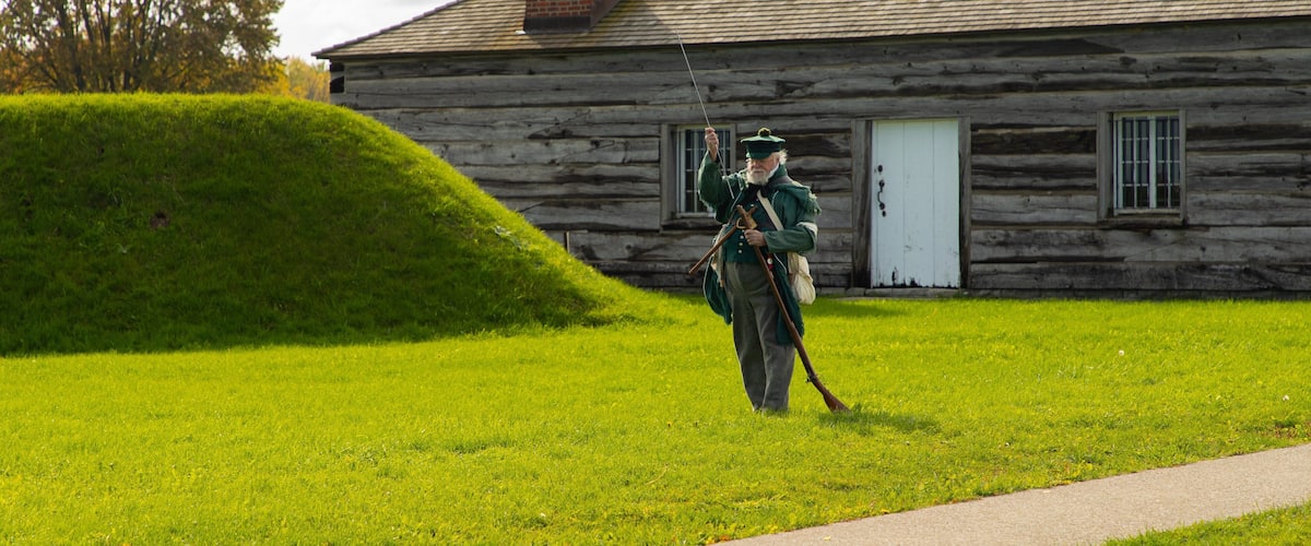 Fort George National Historic Site showing a small town or village and heritage elements as well as an individual male