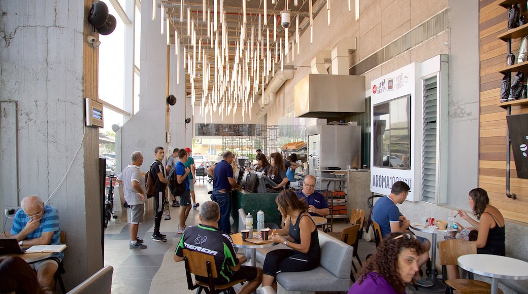 Old Tel Aviv Port featuring café lifestyle and interior views as well as a small group of people