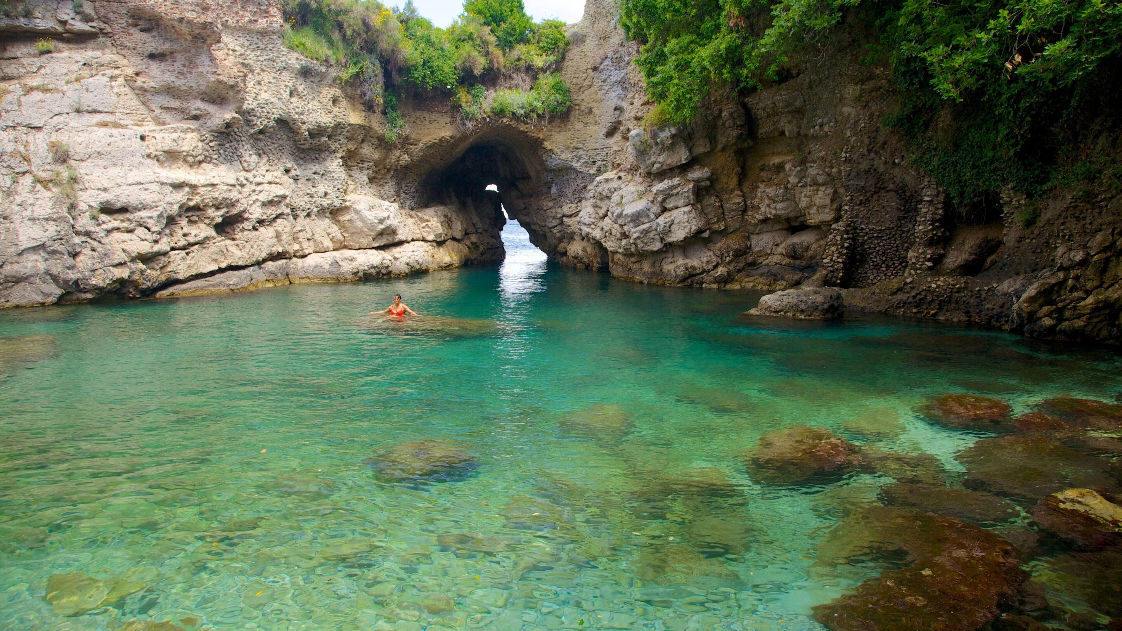 Baths of Queen Giovanna showing swimming and rugged coastline