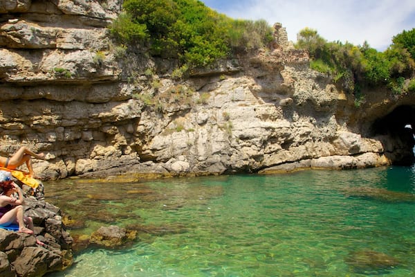 Baths of Queen Giovanna showing rugged coastline as well as a small group of people