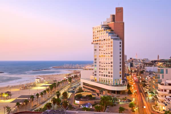Frishman Beach featuring a sunset, a sandy beach and a city