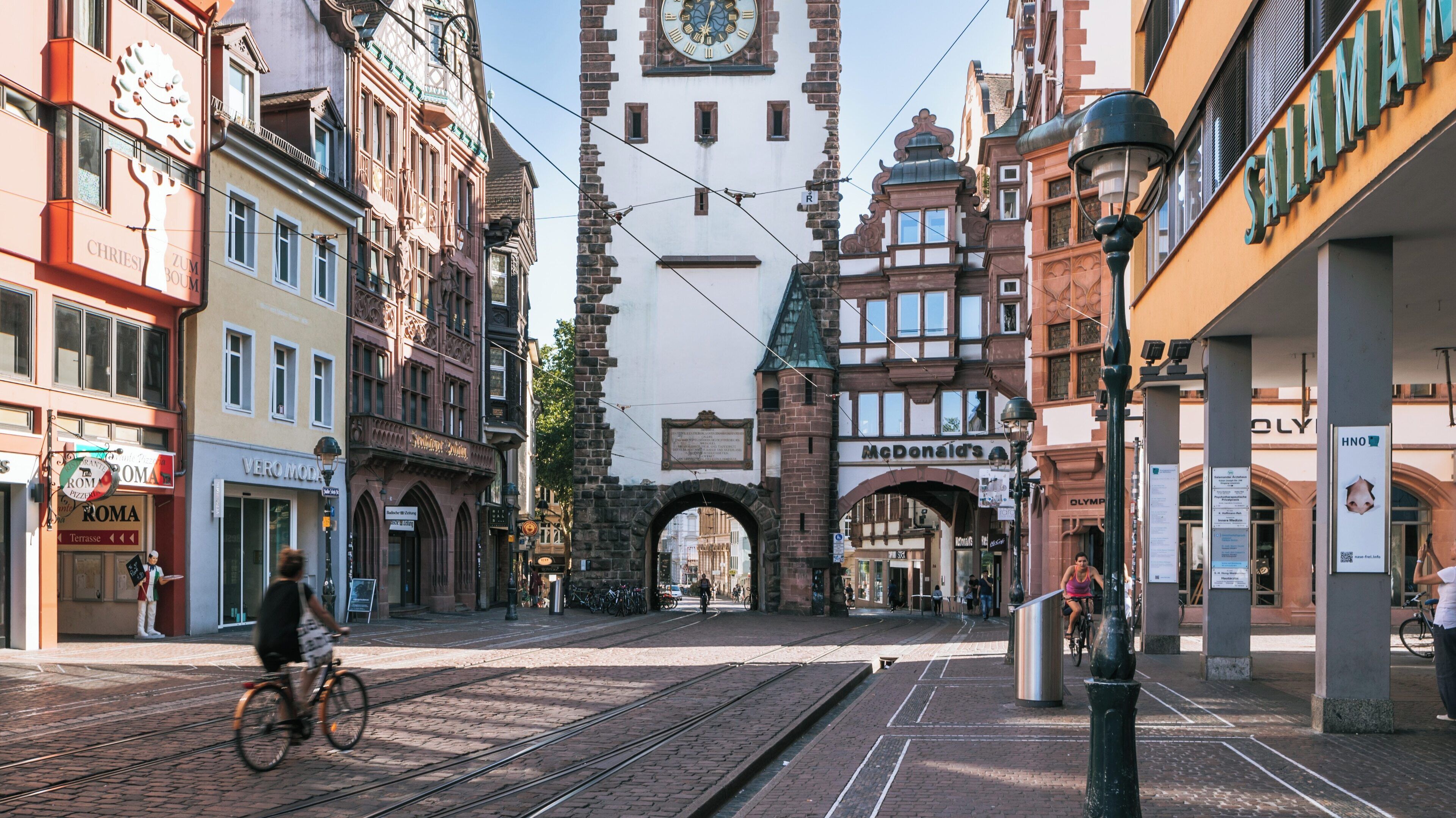 Martinstor Gate in Freiburg im Breisgau showcases historic architecture and vibrant street life in Baden-Württemberg, Germany