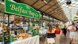 A market stall named "The Belfast Bap Co." with a variety of baked goods displayed.