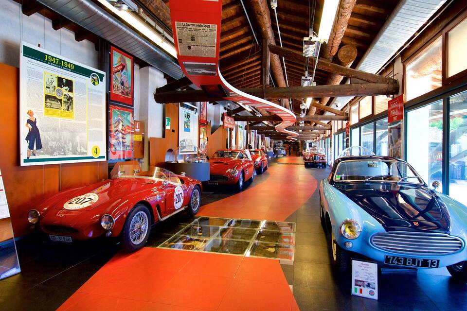 A vintage car museum with classic cars on display.