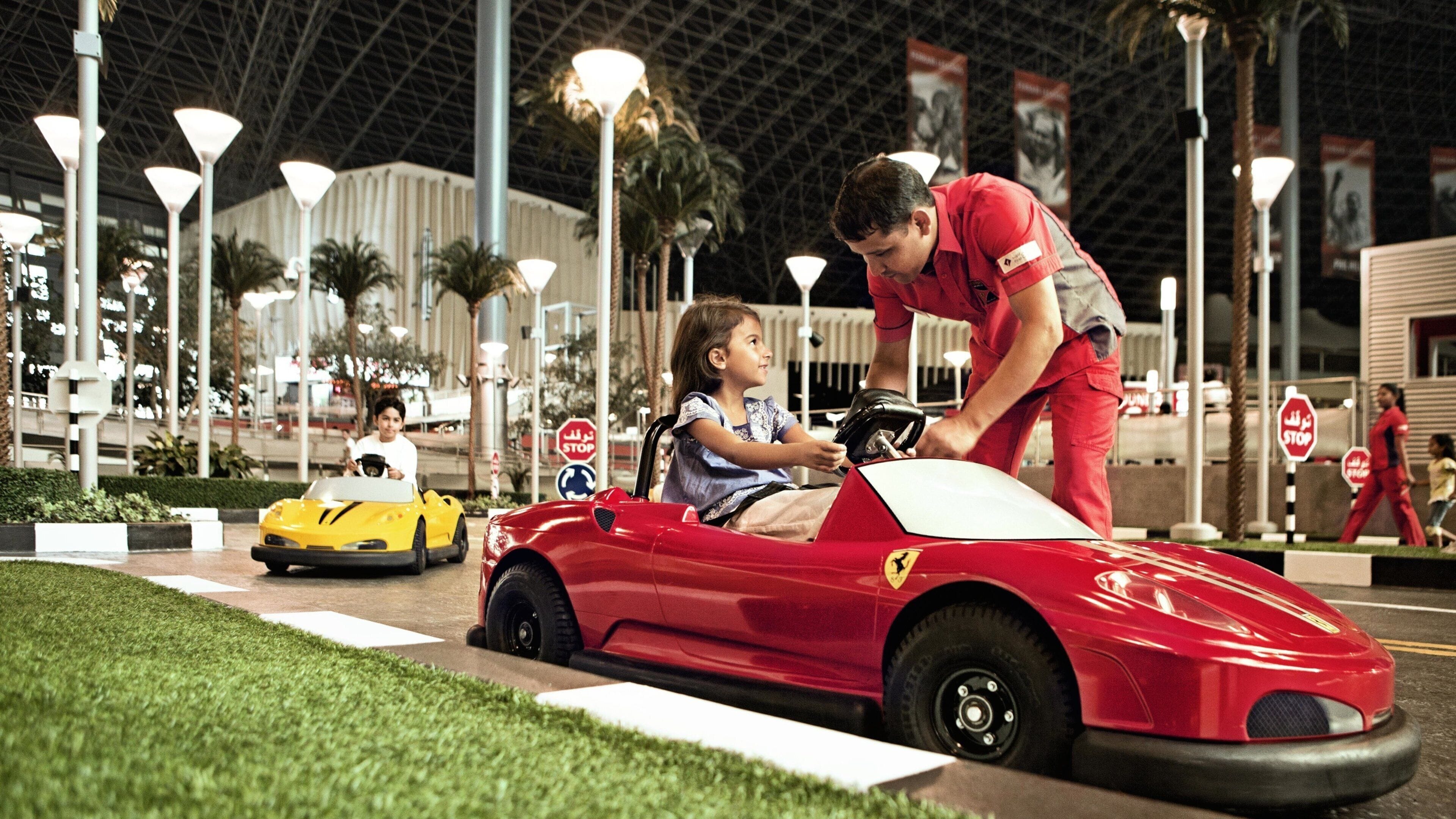 Ferrari World showing rides and interior views as well as children