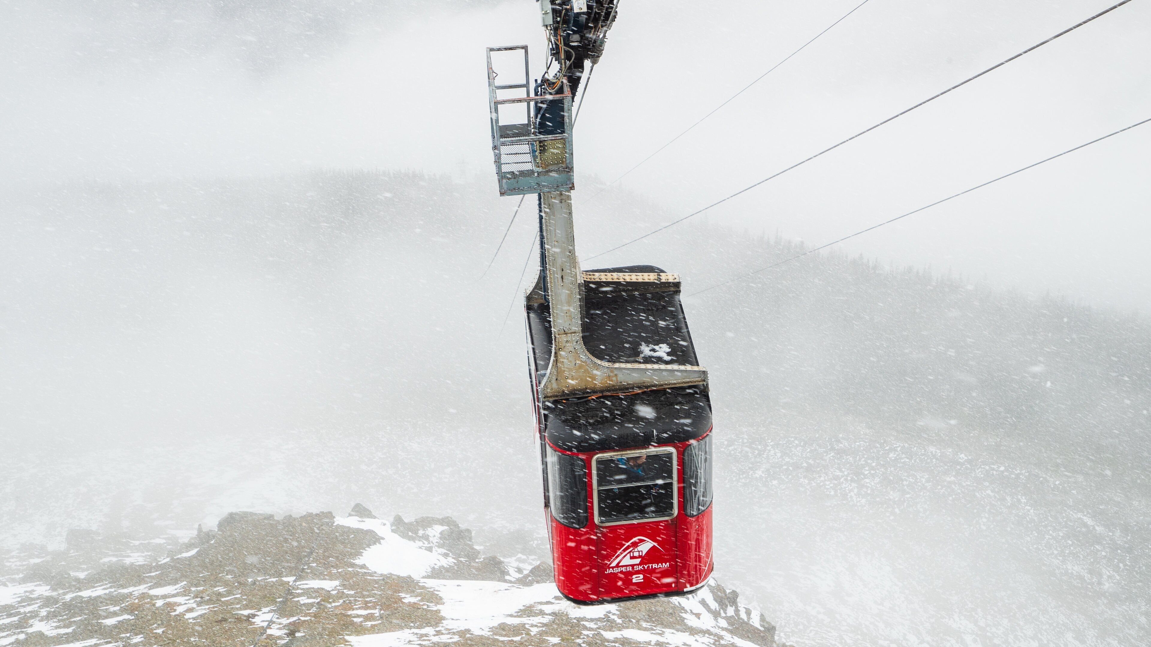 Jasper SkyTram which includes mist or fog, a gondola and snow