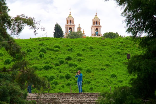 Great Pyramid of Cholula showing a church or cathedral and tranquil scenes as well as an individual male
