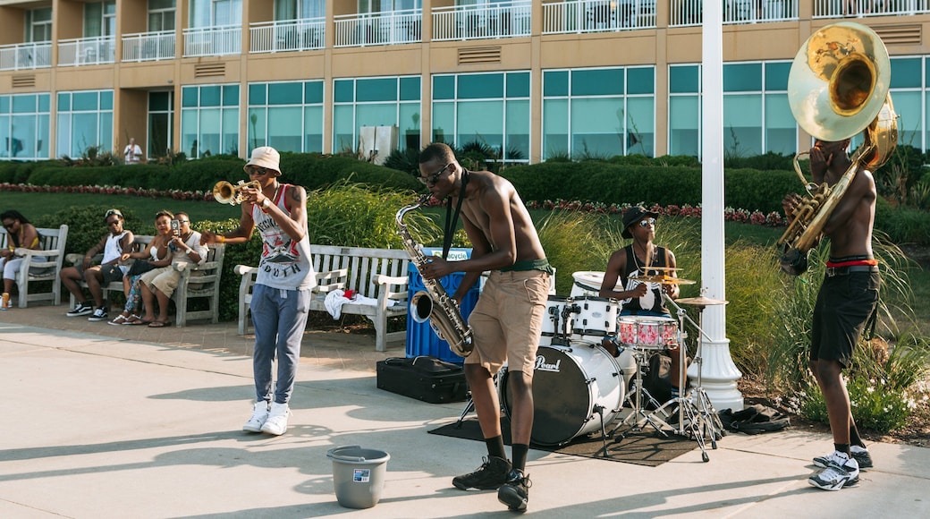 Virginia Beach Boardwalk showing street performance and music as well as a small group of people