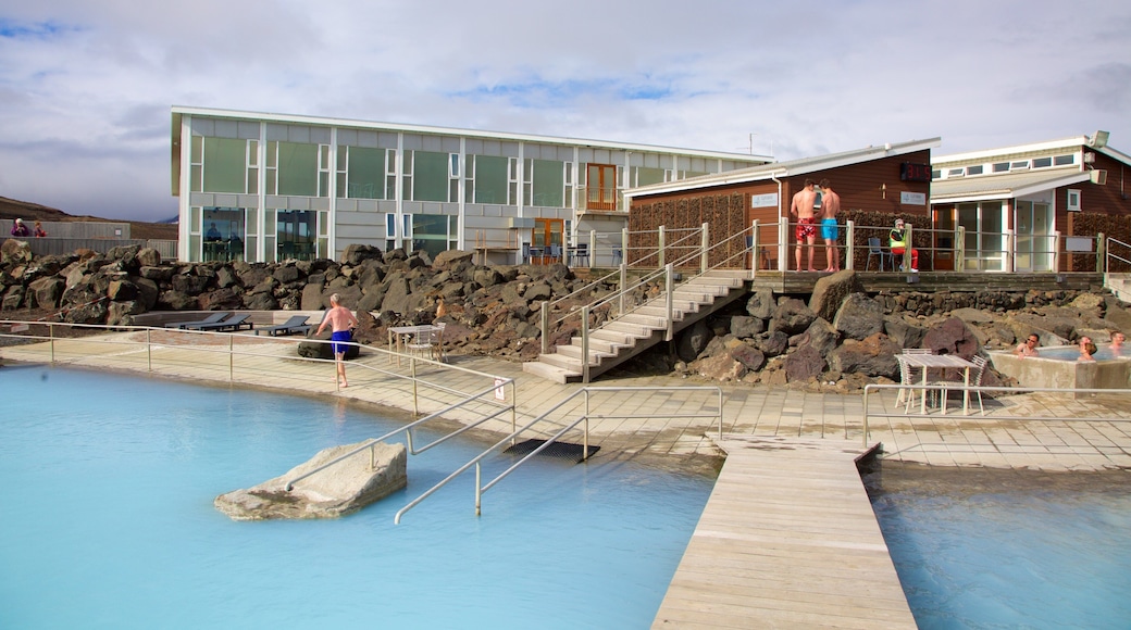 Myvatn Nature Baths featuring a hot spring and a luxury hotel or resort as well as a small group of people