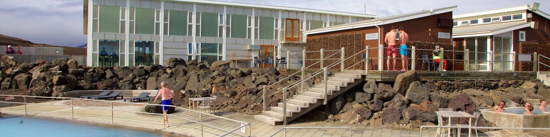 Myvatn Nature Baths featuring a hot spring and a luxury hotel or resort as well as a small group of people