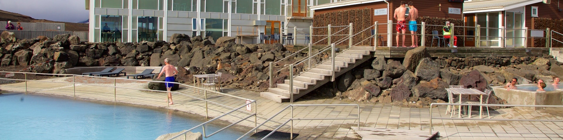 Myvatn Nature Baths featuring a hot spring and a luxury hotel or resort as well as a small group of people