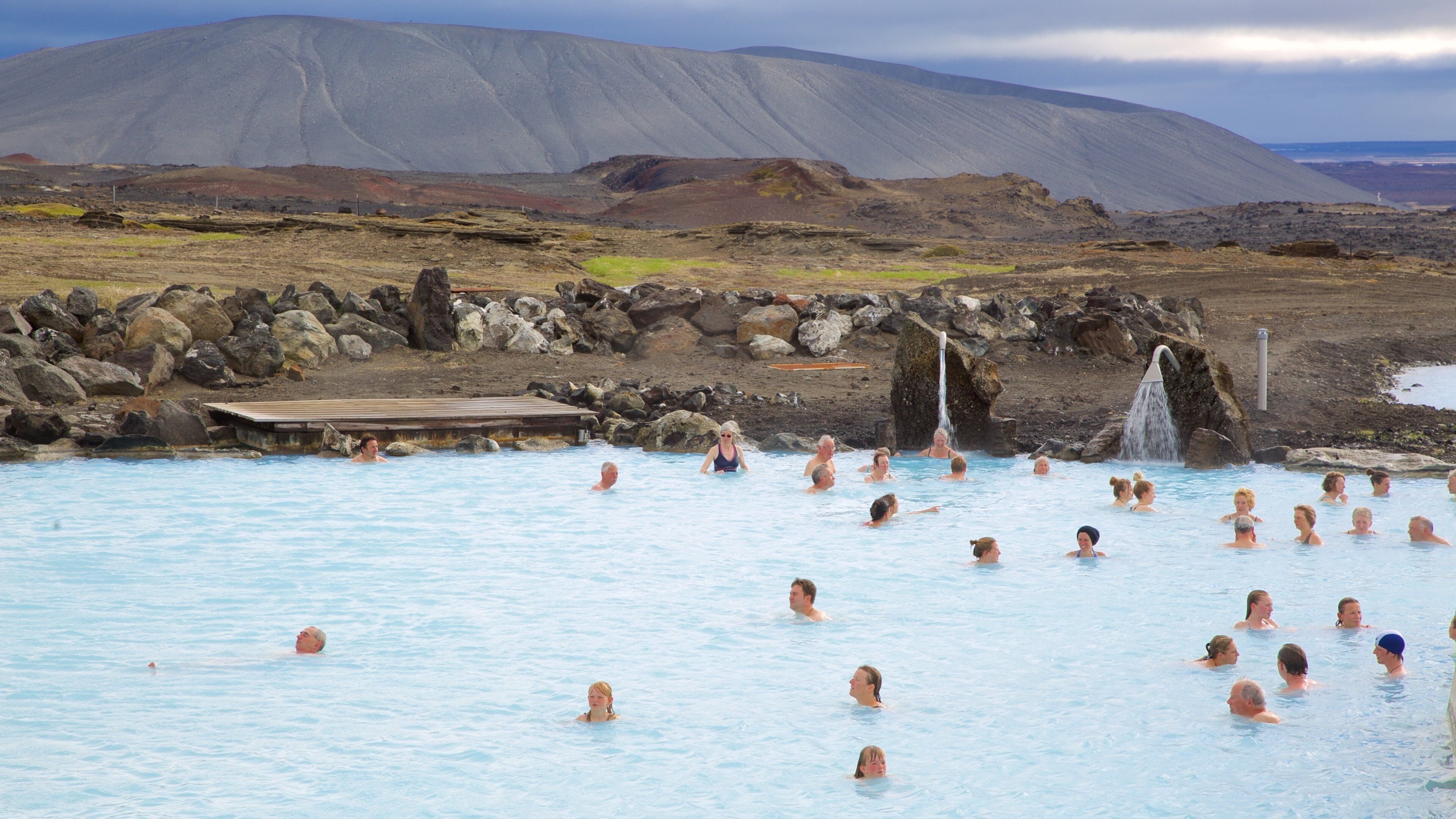 Myvatn Nature Baths showing swimming, a hot spring and rugged coastline