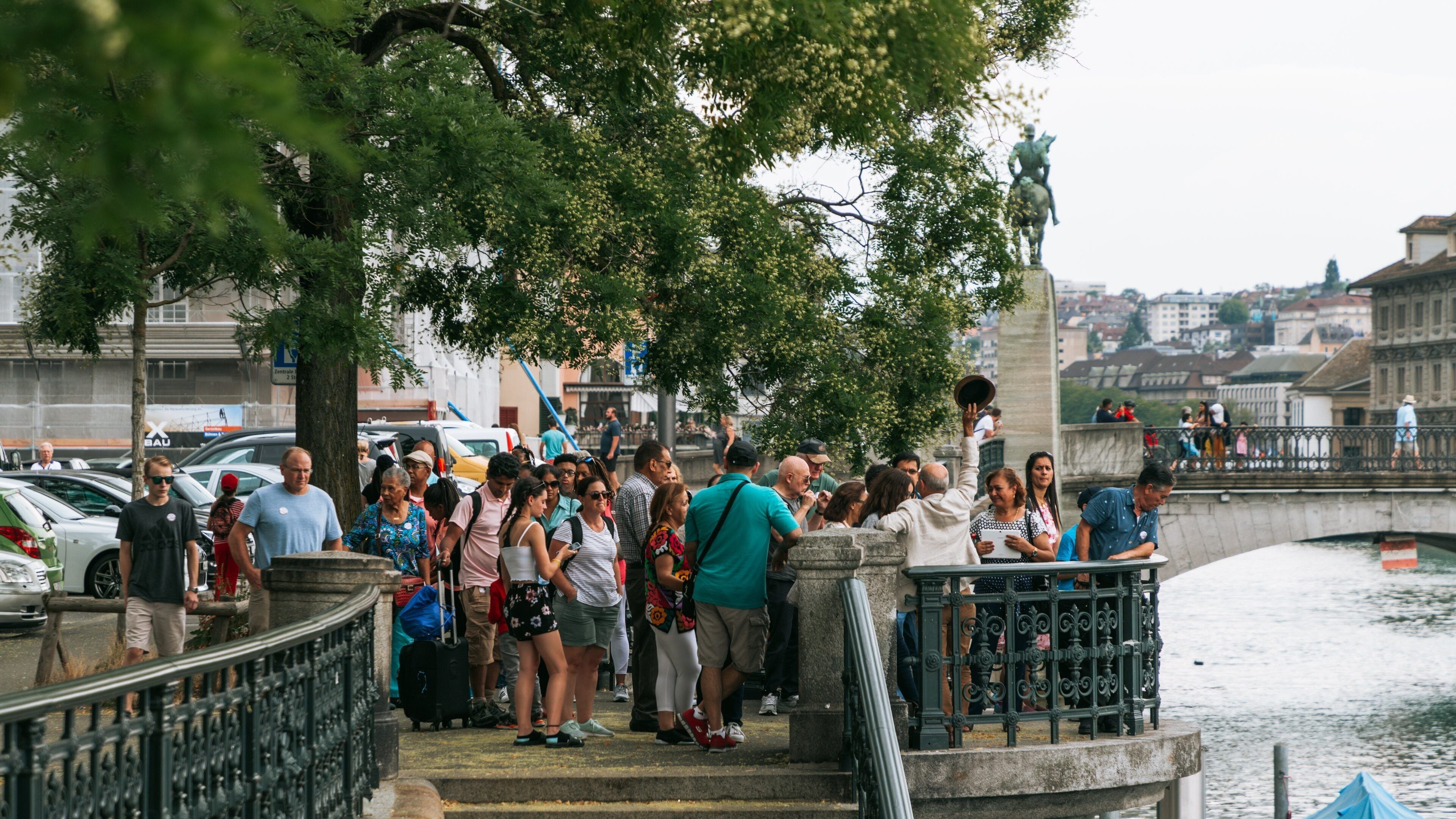 Old Town Zürich showing views and a river or creek as well as a small group of people