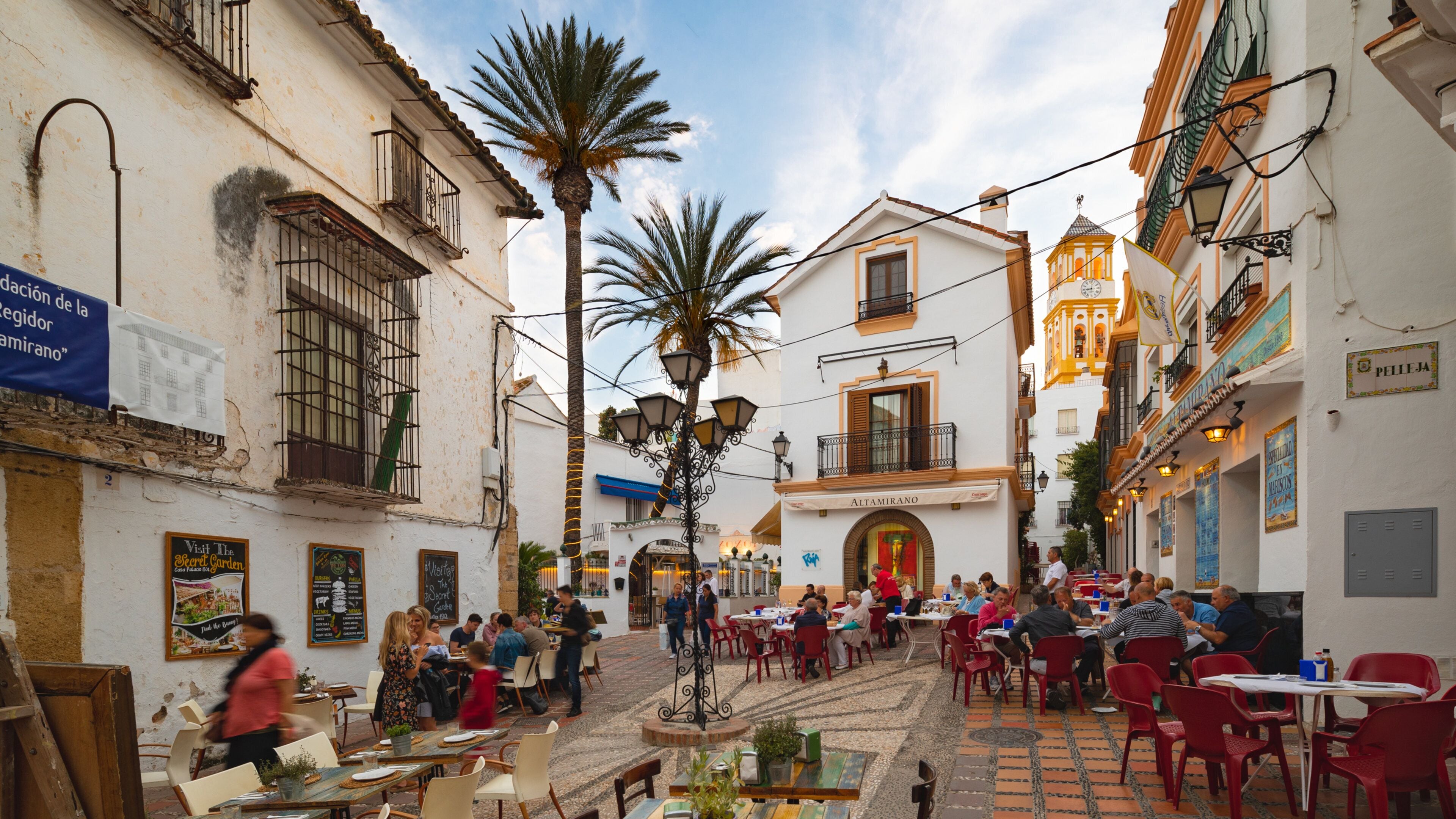 Marbella Old Town featuring outdoor eating as well as a small group of people