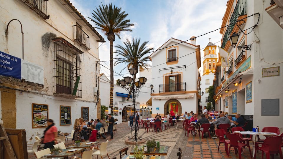 Marbella Old Town featuring outdoor eating as well as a small group of people