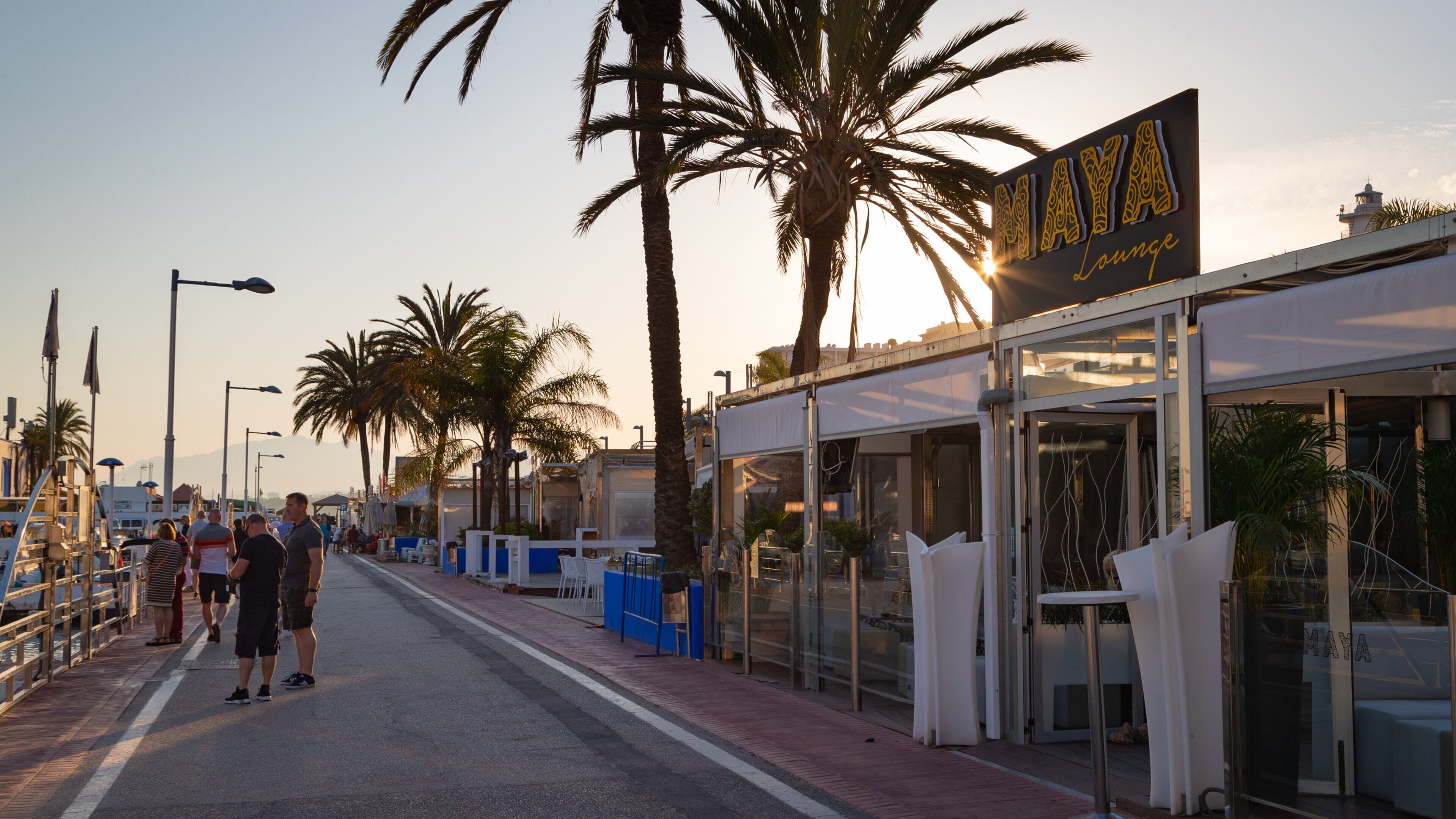 Marbella Marina featuring a sunset and signage