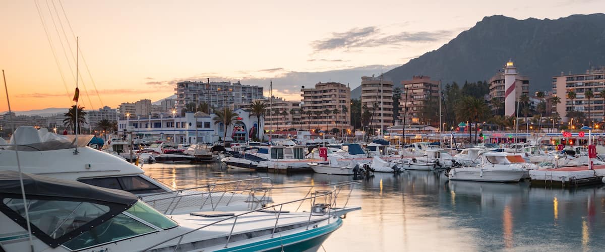 Marbella Marina which includes a bay or harbor and a sunset