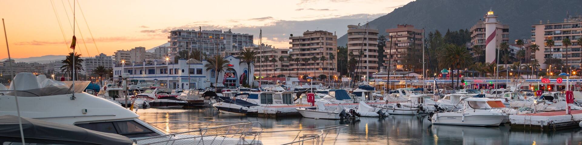 Marbella Marina which includes a bay or harbor and a sunset