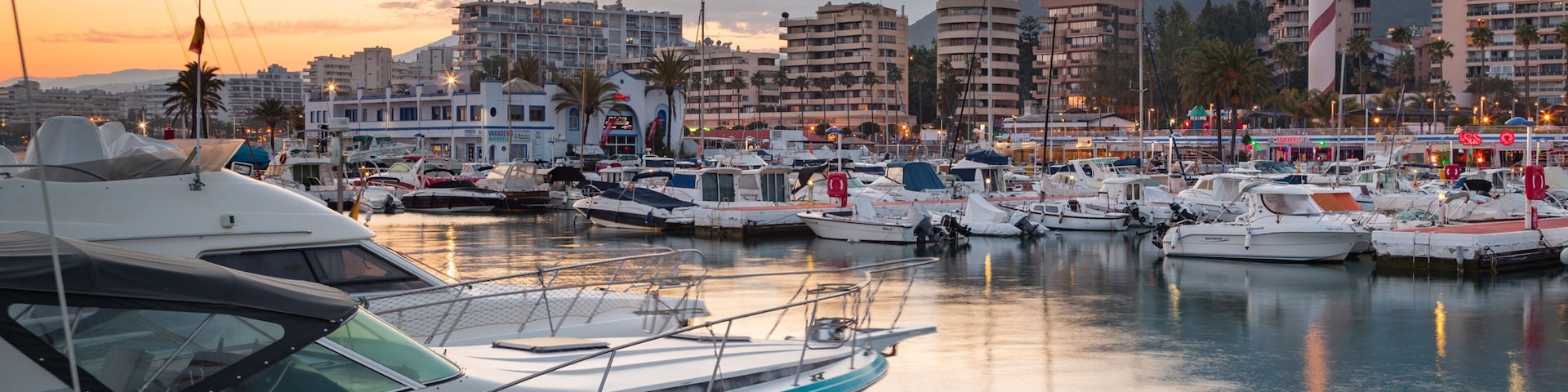 Marbella Marina which includes a bay or harbor and a sunset