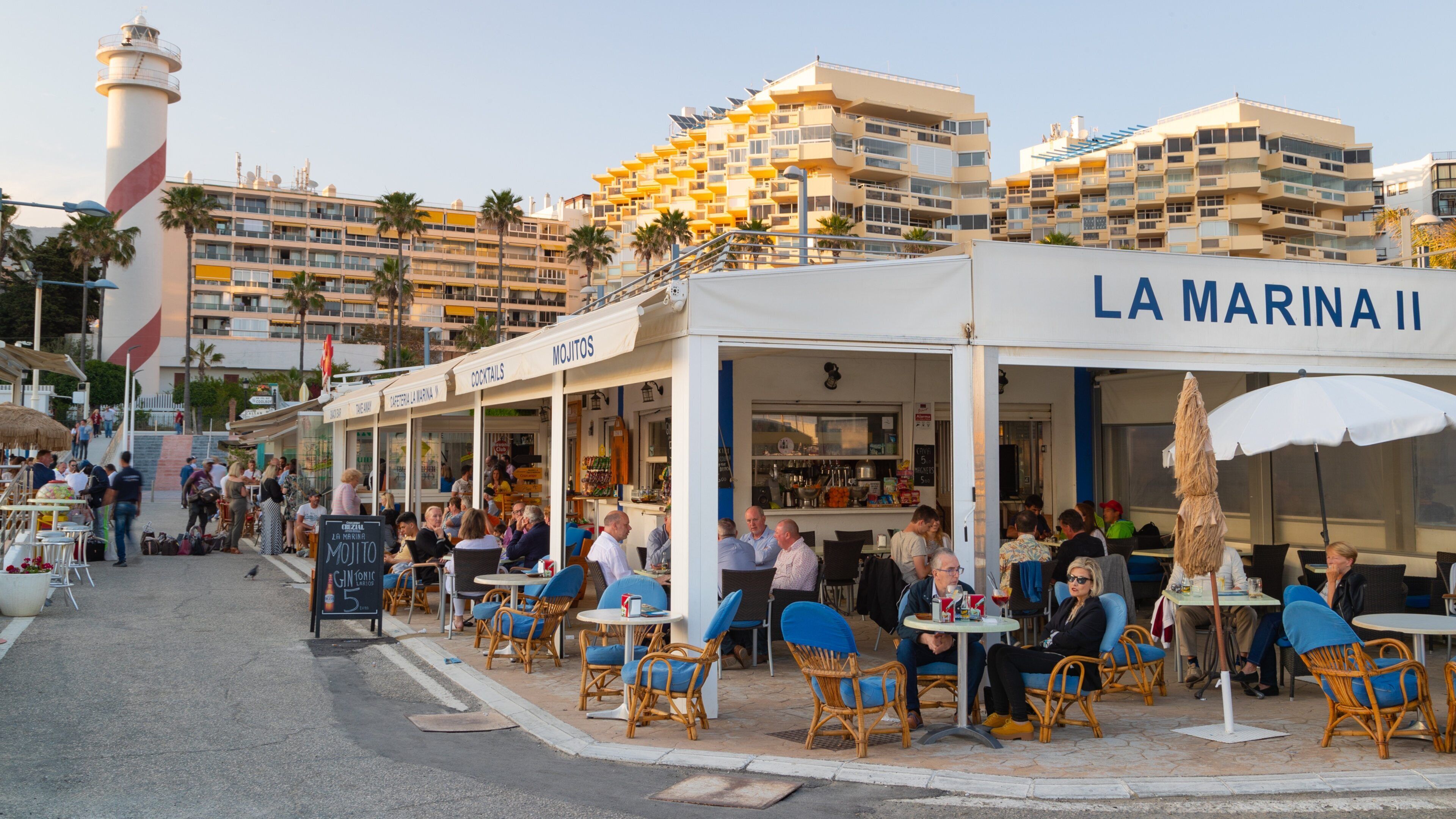 Marbella Marina which includes outdoor eating as well as a small group of people