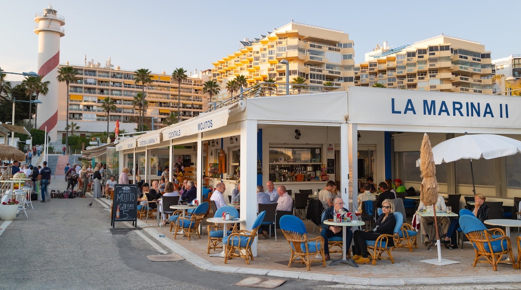 Marbella Marina which includes outdoor eating as well as a small group of people