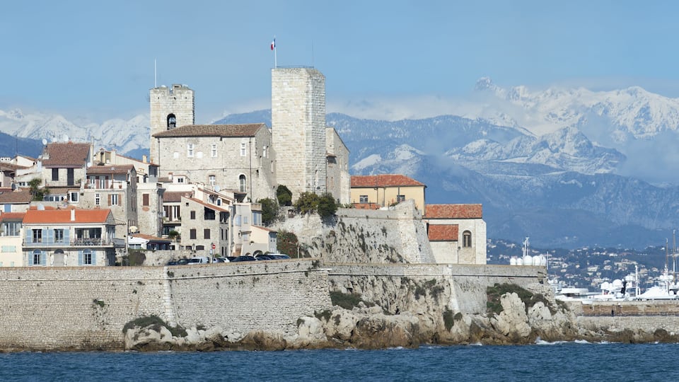 View over Antibes old town and snow-covered Alpes, Alpes-Maritimes Department, Cote d’Azur, France