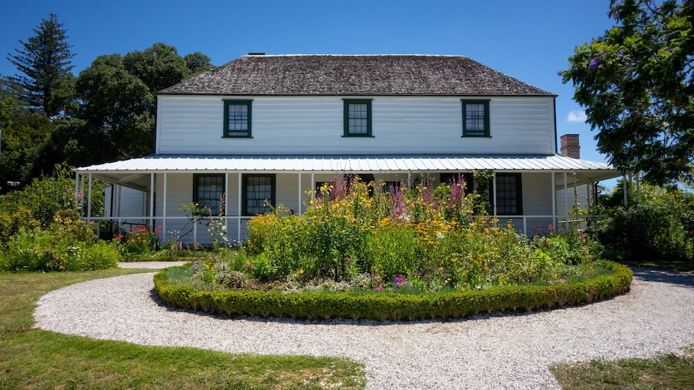 Stone Store showing wildflowers and a house