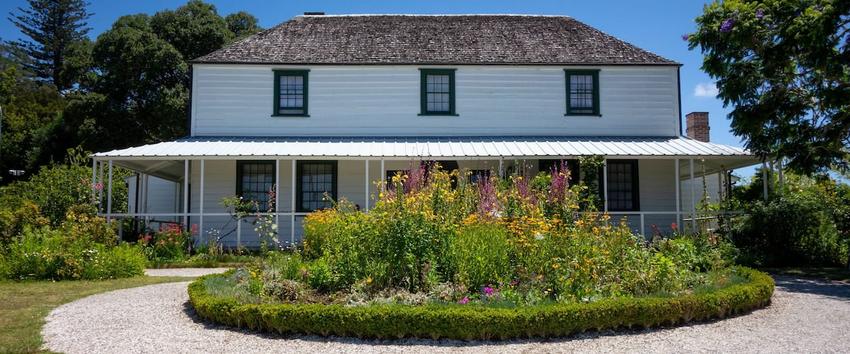 Stone Store showing wildflowers and a house