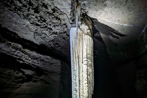A cave with stalactites hanging from the ceiling.
