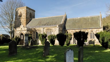 The oldest part of the church dates back to the 13th century. The church was enlarged during the 15th century and later had restoration work done under Sir George Gilbert Scott in the 19th century. The arcade – most of the windows and the south porch date from this time. The octagonal font is 13th/15 century. The wrought iron top is modern. The church has north and south aisles and a north chapel. The late 13th C 3 bay arcades have double chamfered arches with octagonal piers and moulded capitals. On the voussoirs are extensive traces of red painted foliage. The lower part of the tower is 13th century and retains the original narrow tower arch and small lancet window in the west wall. The upper tower was added in the 14th century together with the window. The reredos dated 1860 is mosaic and marble and displays Italian workmanship. Restoration dates of interest:- 1851 WA Nicholson – Architect – work undertaken in chancel included the painted ceiling 1859-60 Sir George G Scott – further restoration 1867 Reredos designed by RJ Withers and made by Salviati 1870-74 George G Scott Jnr, urgent restoration work.