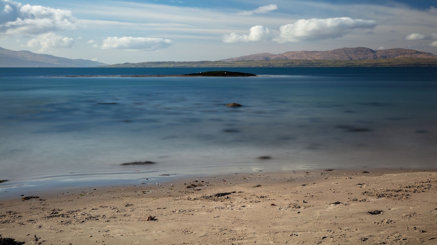 Sunny afternoon looking across Ganavan Bay with the Isle of Mull in the distance. Oban, Argyll and Bute, Scotland.