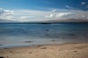 Sunny afternoon looking across Ganavan Bay with the Isle of Mull in the distance. Oban, Argyll and Bute, Scotland.
