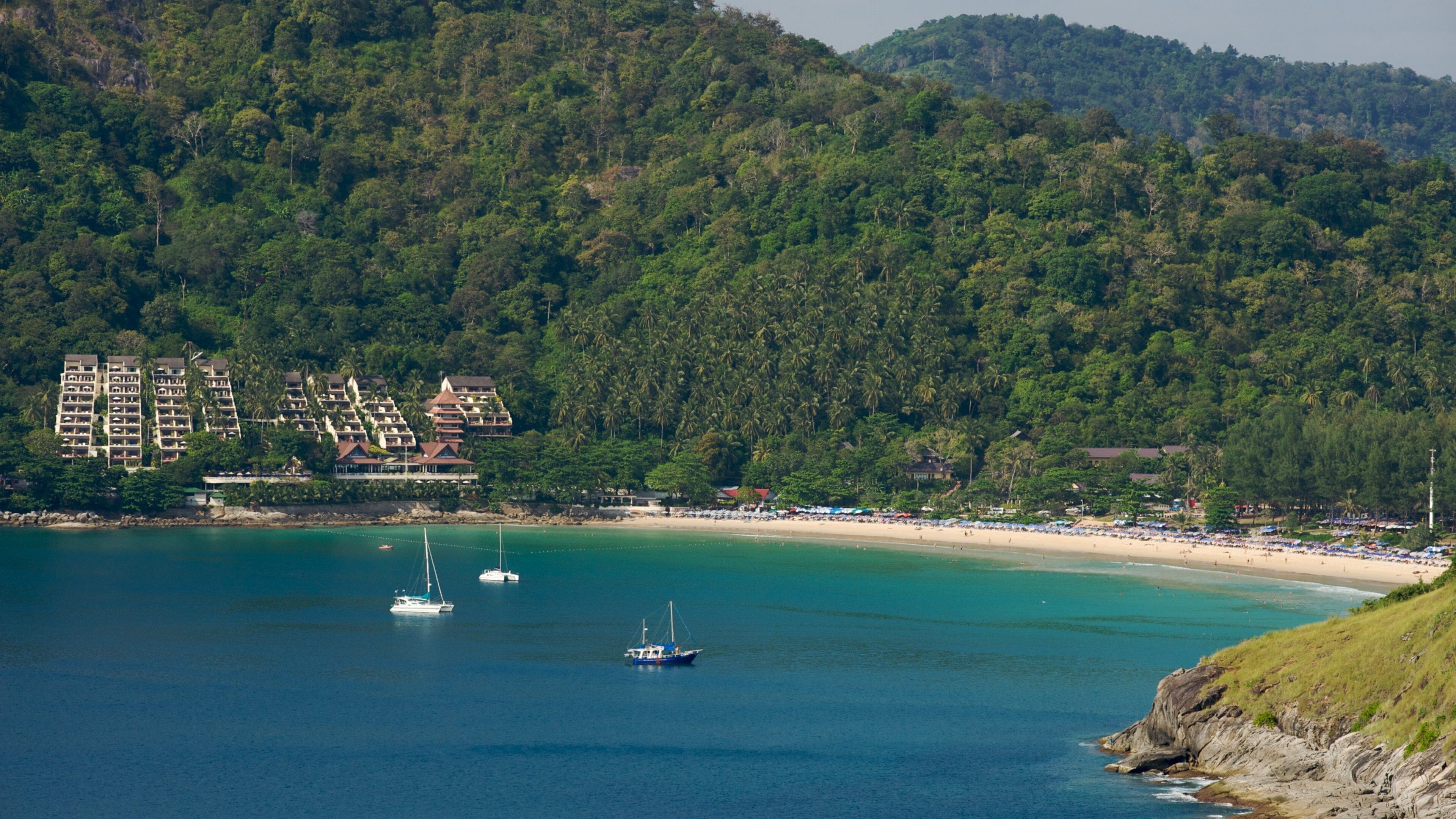 Stunning Nai Han Beach in Phuket, a serene getaway with clear waters and lush greenery