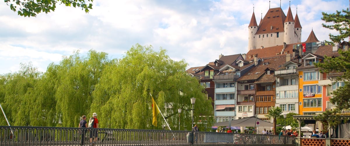 A bridge over a river with a castle in the background.
