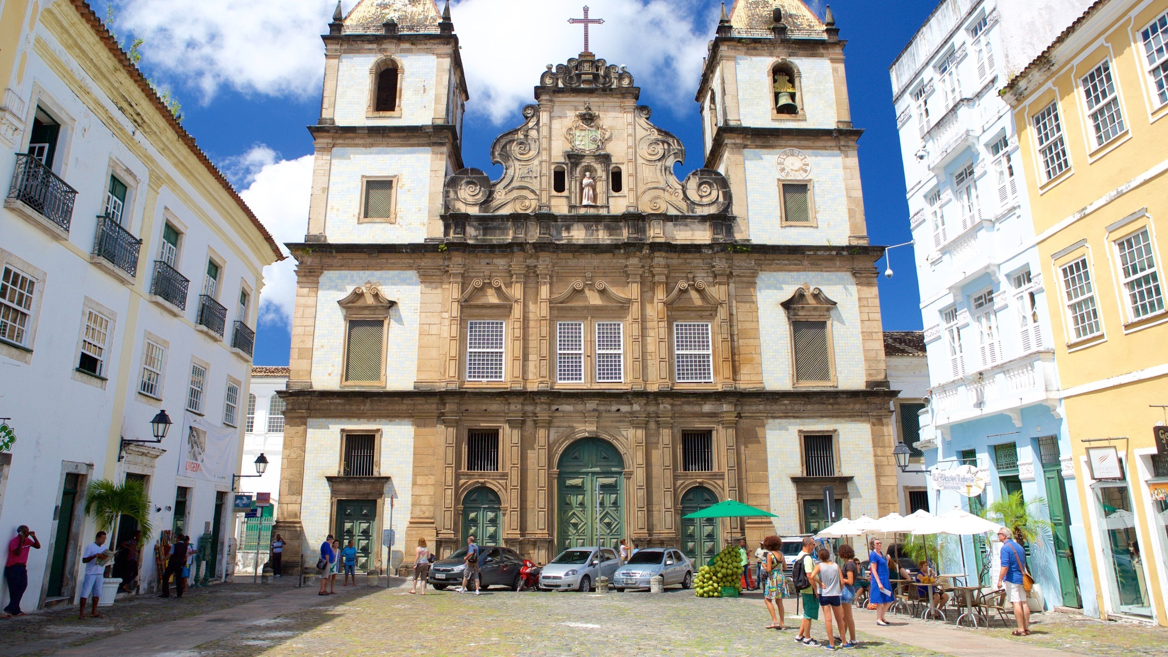 Pelourinho featuring a church or cathedral and street scenes as well as a small group of people