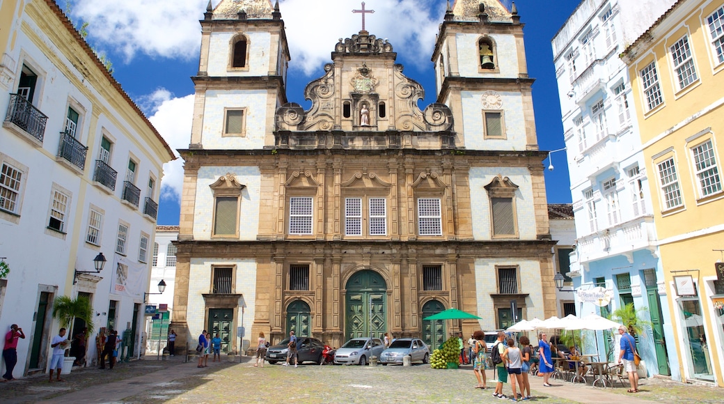 Pelourinho featuring a church or cathedral and street scenes as well as a small group of people
