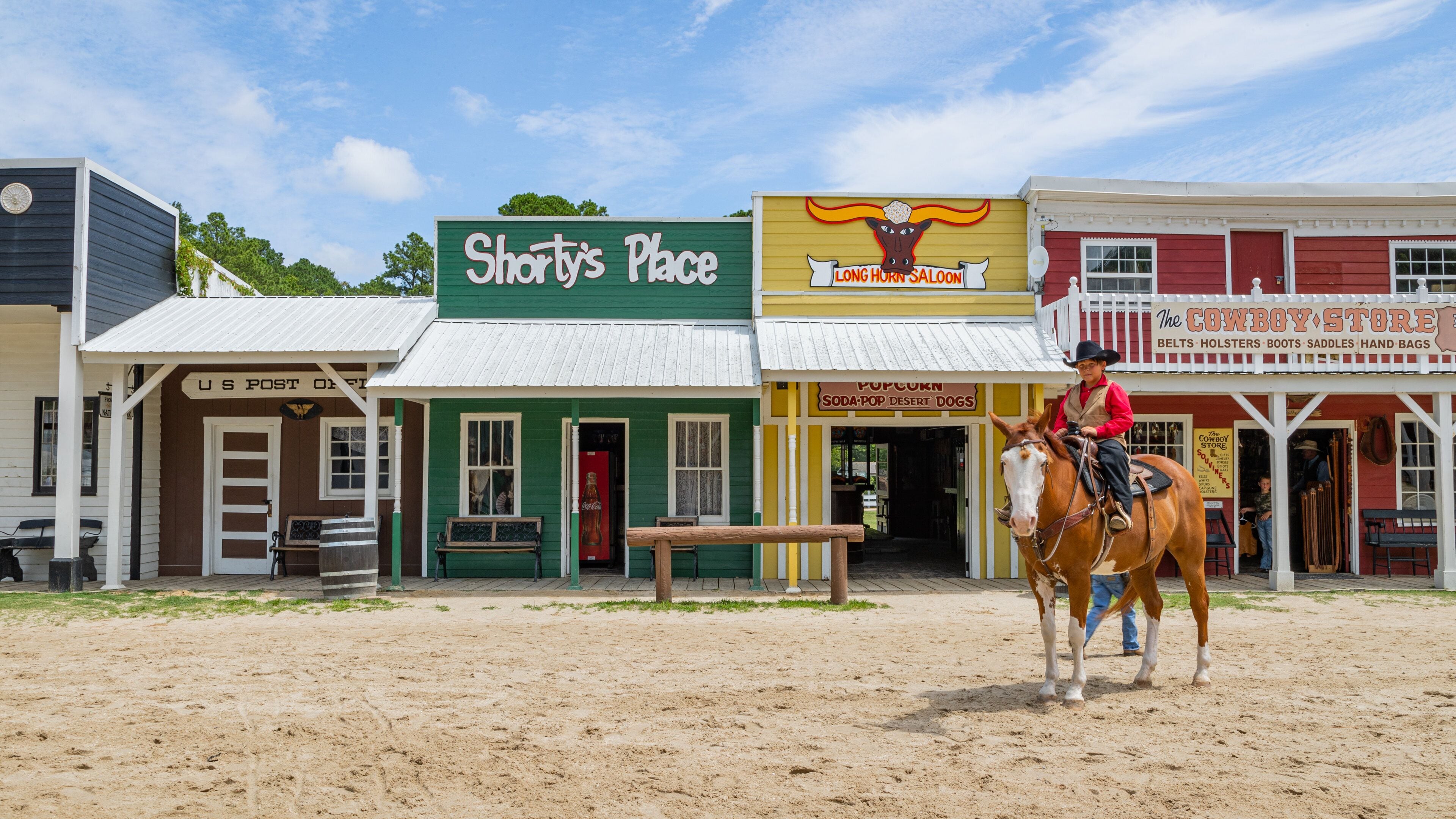 Frontier Town Water Park and Golf which includes horseriding and a small town or village as well as an individual male