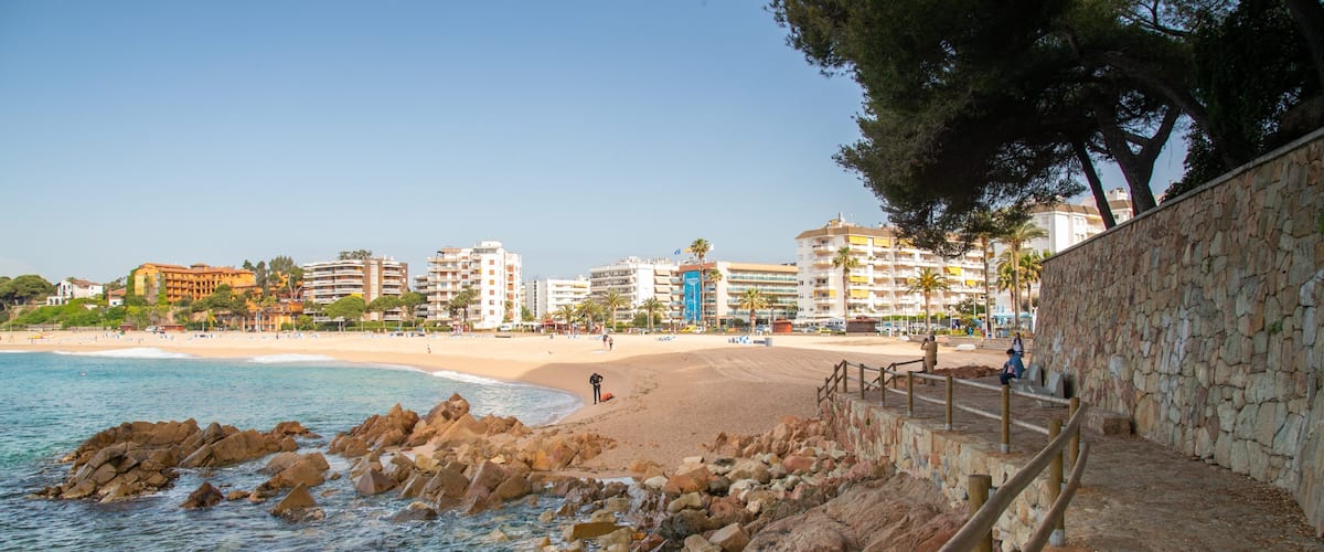 Fenals Beach showing a coastal town, a sandy beach and general coastal views