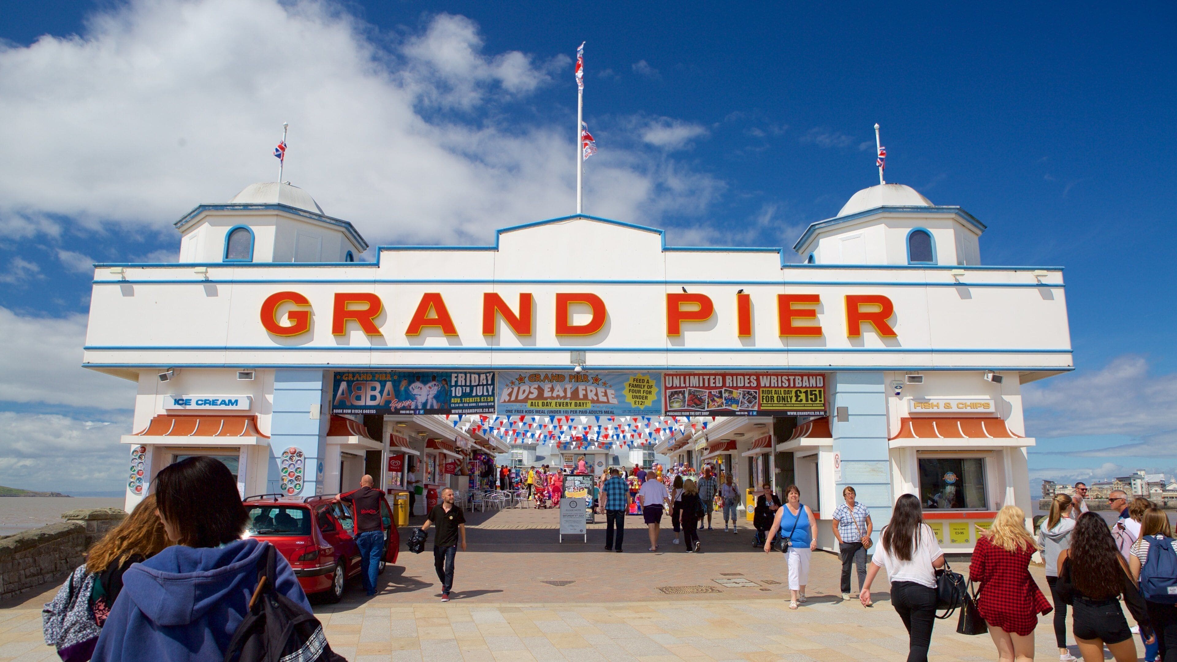 The Grand Pier which includes a festival and signage as well as a large group of people