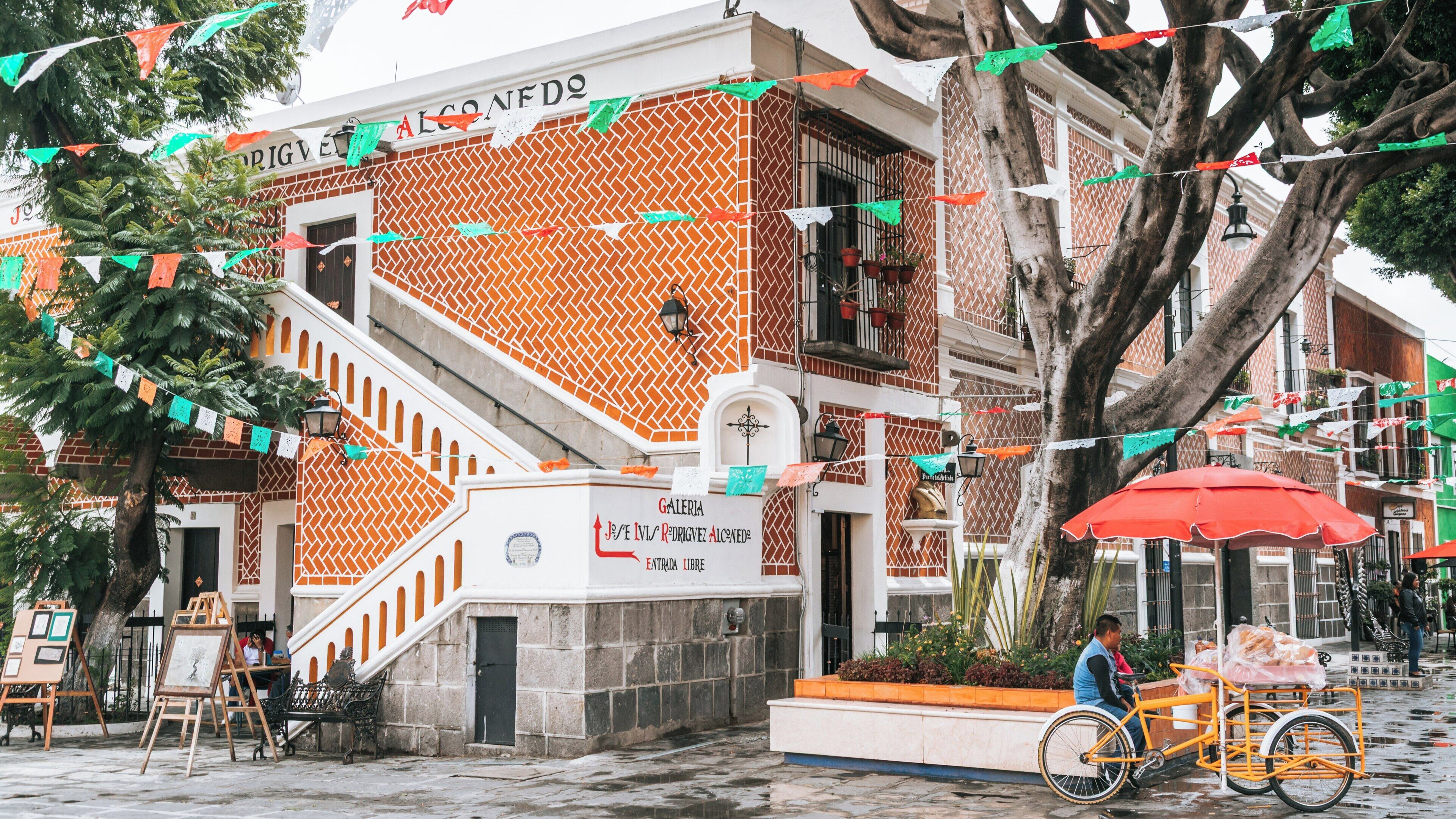 Colorful decorations and vibrant life in Artist Quarter of Puebla Historic Center, showcasing local culture and architecture in Puebla, Mexico