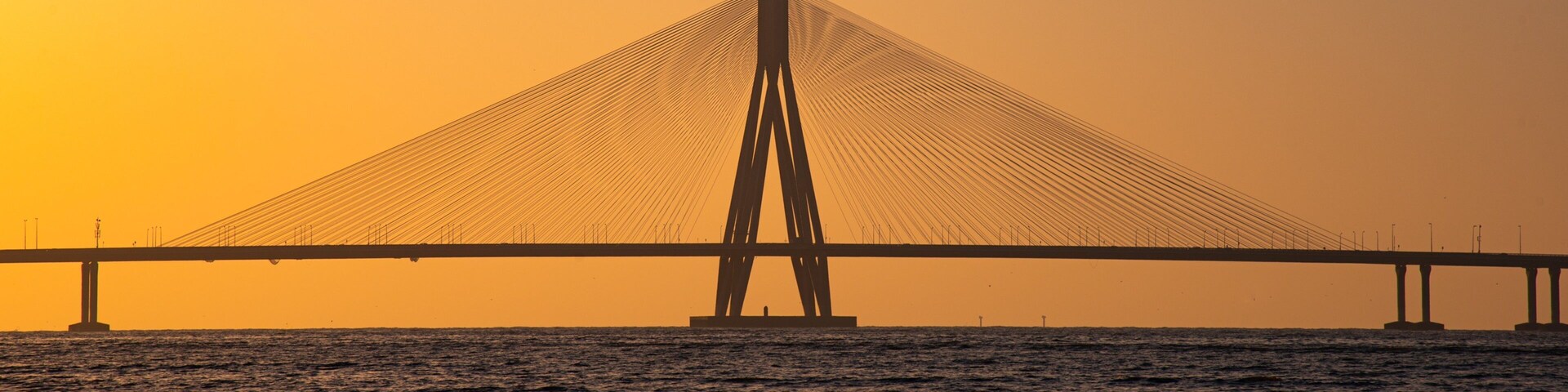 Bandra-Worli Sea Link showing a river or creek, a bridge and a sunset