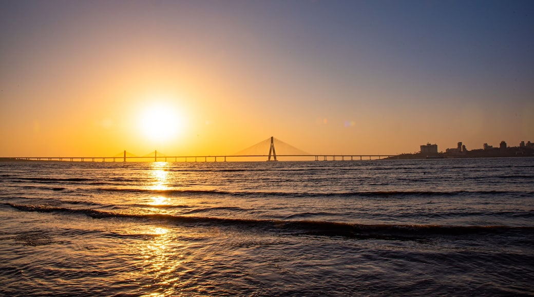 Bandra-Worli Sea Link which includes a river or creek, a bridge and a sunset