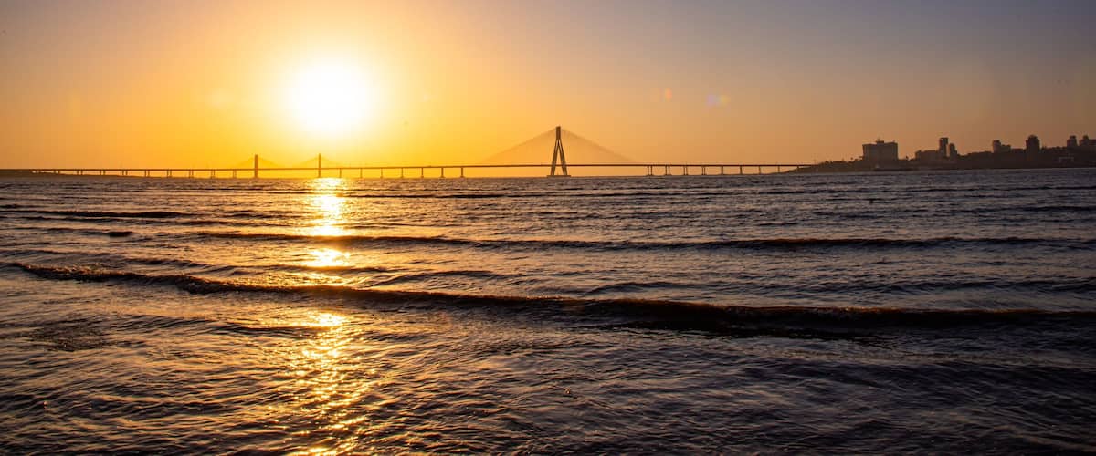 Bandra-Worli Sea Link which includes a river or creek, a bridge and a sunset