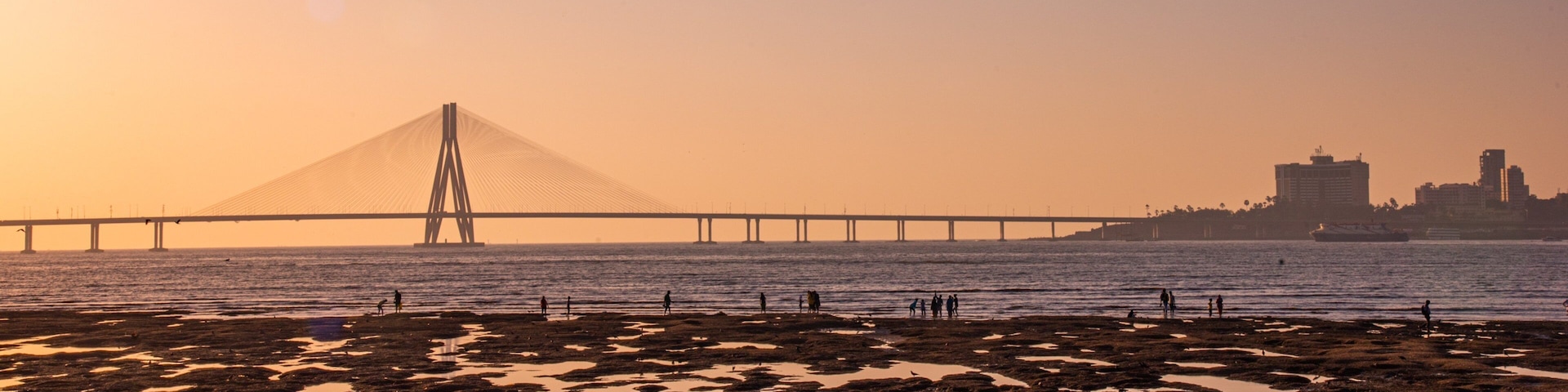 Bandra-Worli Sea Link featuring a sunset, a river or creek and a bridge