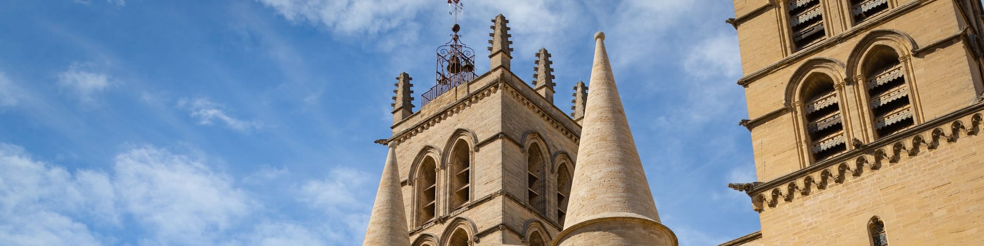 A historic building with tall, pointed towers and arched windows.