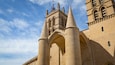 A historic building with tall, pointed towers and arched windows.