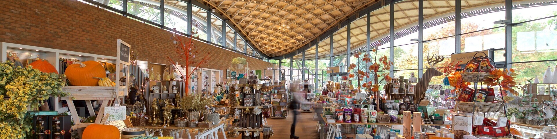 Un mercado interior espacioso con vigas de madera en el techo y paredes de ladrillo.