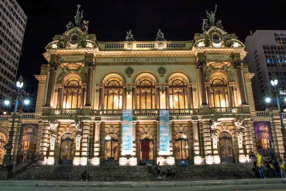 Teatro Municipal with ornate architecture and illuminated windows.